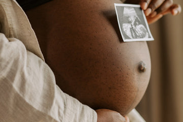 Image showing a pregnant woman hold an ultrasound